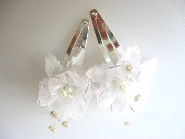 White hair flower clips with silver trim